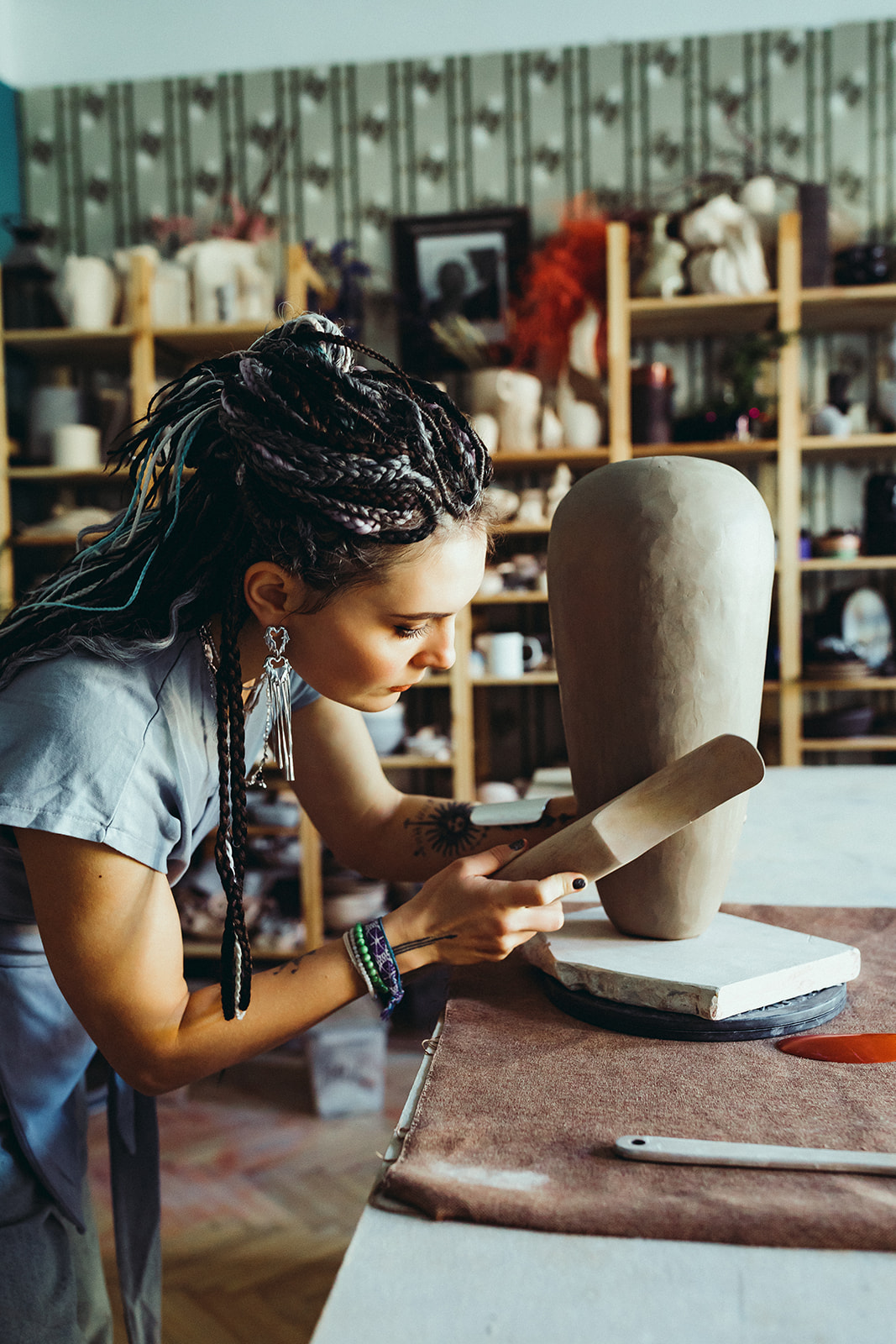 Roksolana shaping a hand-built vessel in the studio